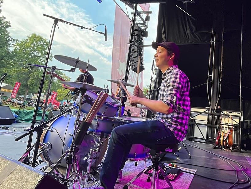 Davi on a stage playing drums